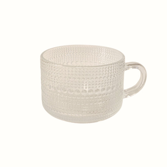 Tazza in vetro trasparente con decorazione geometrica a rilievo e manico